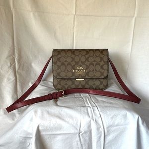 Coach saddle bag in signature canvas with red accent